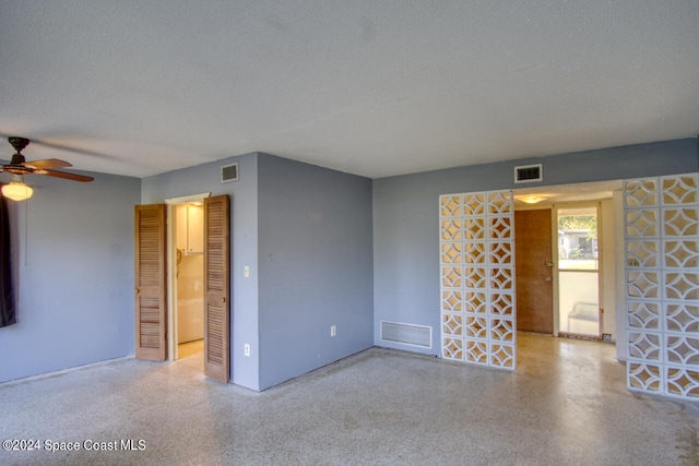 empty room featuring a textured ceiling and ceiling fan