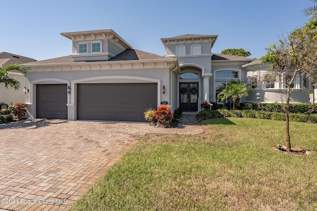 view of front of property featuring a garage and a front lawn