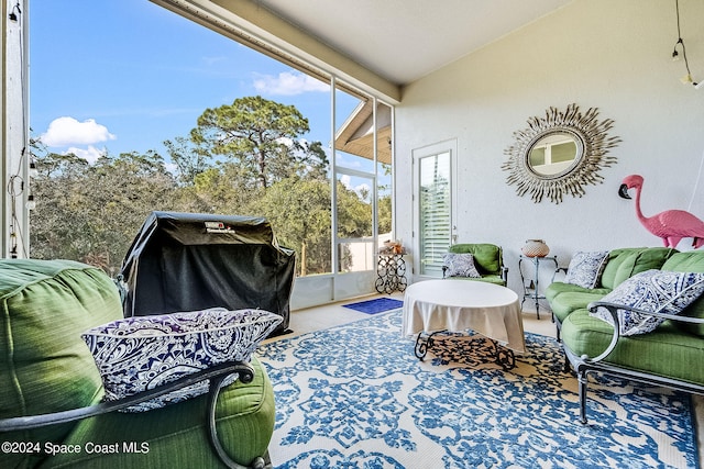 sunroom featuring lofted ceiling