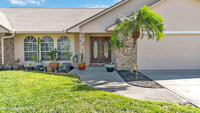 property entrance featuring a yard and a garage