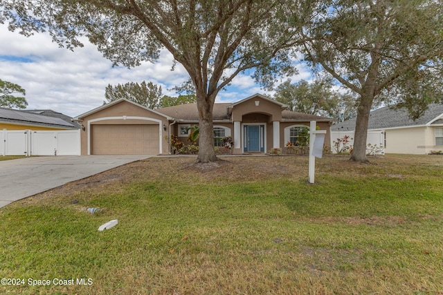 single story home featuring a front yard and a garage