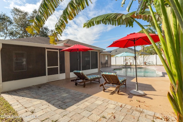 view of patio / terrace featuring a fenced in pool and a sunroom