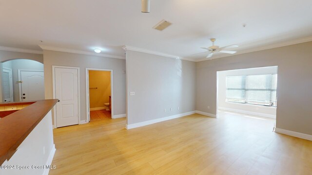 6461 Borasco Dr Unit 2805, Melbourne, FL 32940 - unfurnished room with arched walkways, a ceiling fan, ornamental molding, baseboards, and light wood-type flooring