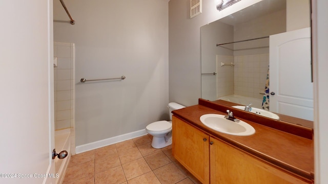 full bathroom featuring toilet, tiled shower / bath, vanity, and tile patterned floors