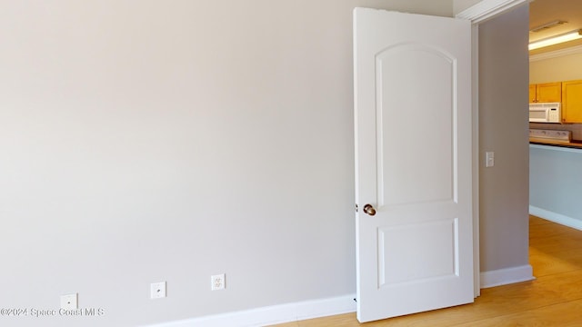 empty room with light hardwood / wood-style flooring