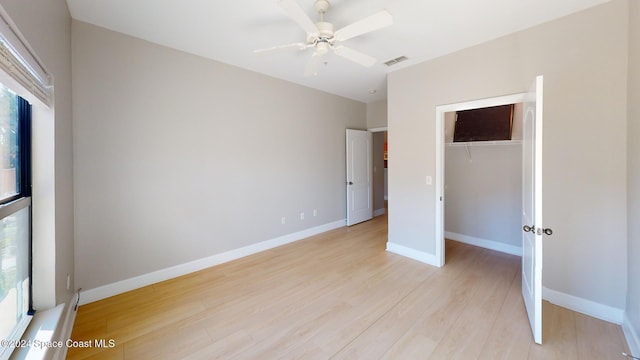 unfurnished bedroom featuring light hardwood / wood-style flooring, multiple windows, and ceiling fan