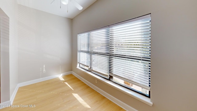 unfurnished room featuring ceiling fan, a wealth of natural light, and hardwood / wood-style floors