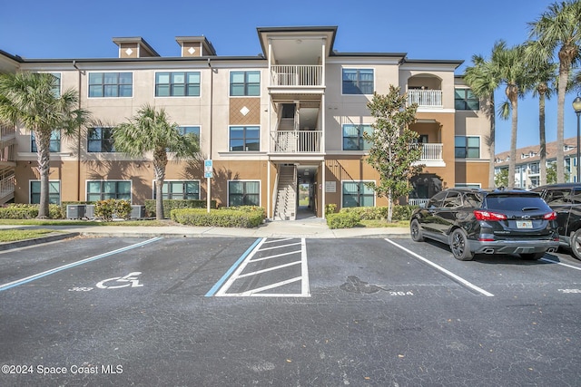 6461 Borasco Dr Unit 2805, Melbourne, FL 32940 - view of building exterior with uncovered parking and central AC unit