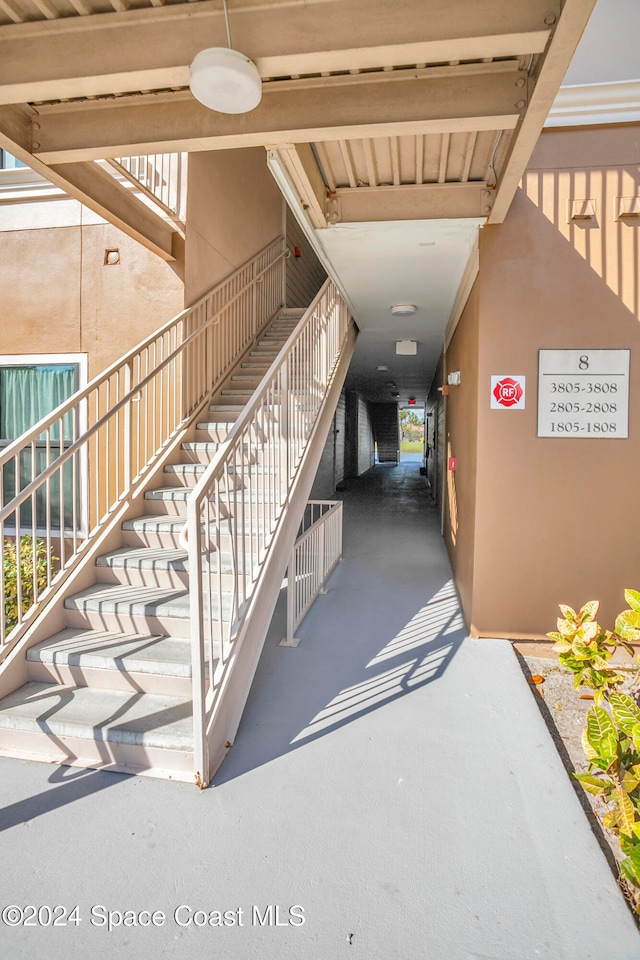 stairs with concrete flooring