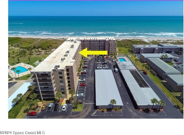 aerial view with a water view and a view of the beach