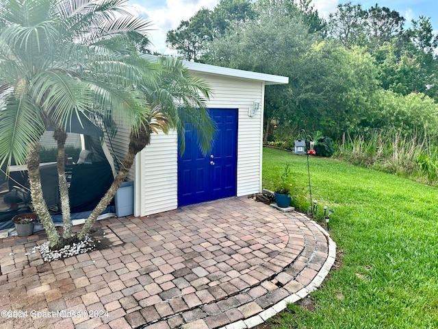 view of outbuilding featuring a lawn