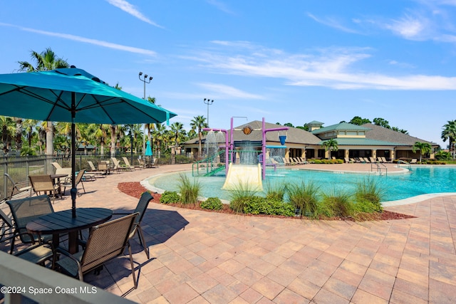 view of swimming pool with a patio and pool water feature