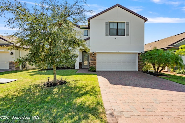 view of front of home featuring a front lawn and a garage