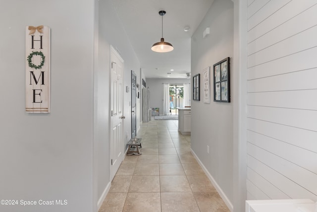 hall featuring light tile patterned floors