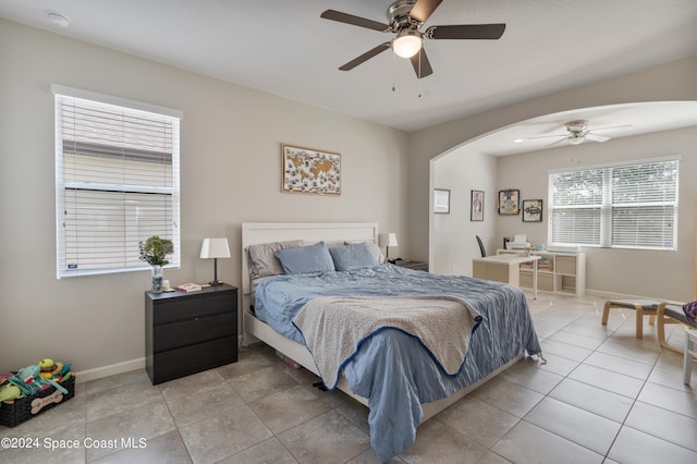 tiled bedroom featuring ceiling fan