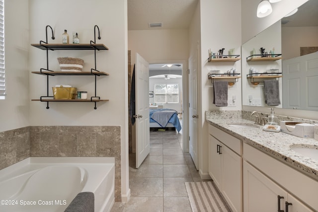 bathroom featuring vanity, tile patterned floors, a washtub, and ceiling fan