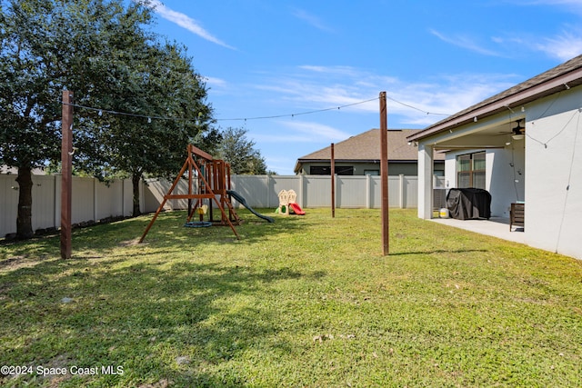 view of yard featuring a patio and a playground