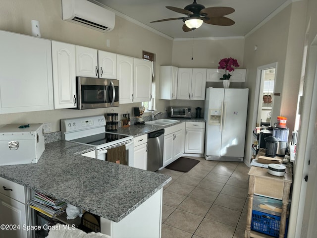 kitchen with a wall mounted AC, appliances with stainless steel finishes, sink, and white cabinetry