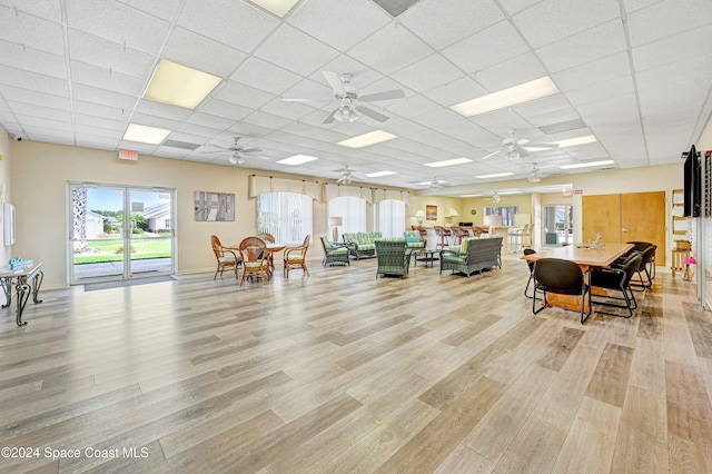 interior space featuring a drop ceiling, light hardwood / wood-style flooring, and ceiling fan