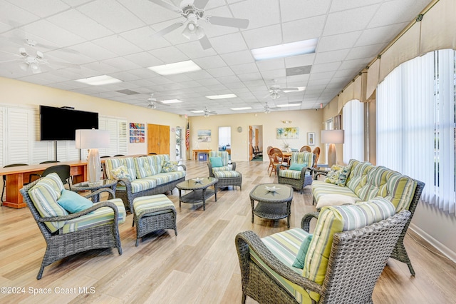 living room featuring a paneled ceiling and light hardwood / wood-style floors