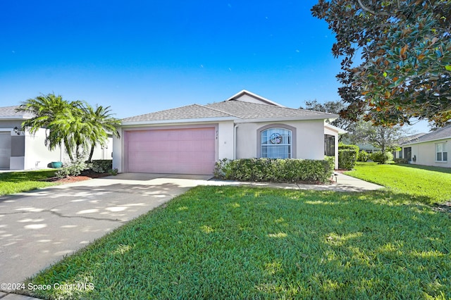 view of front of home with a garage and a front lawn