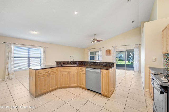 kitchen with ceiling fan, sink, stainless steel appliances, and vaulted ceiling