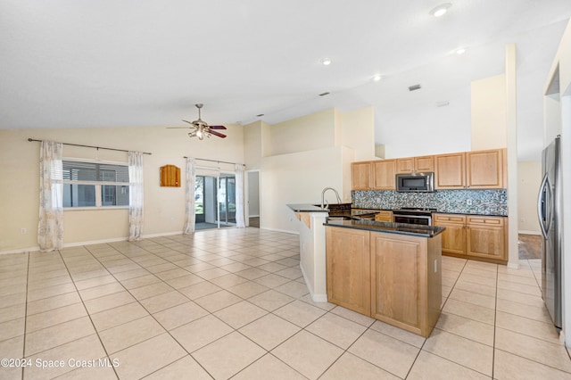 kitchen with backsplash, ceiling fan, light tile patterned floors, and stainless steel appliances