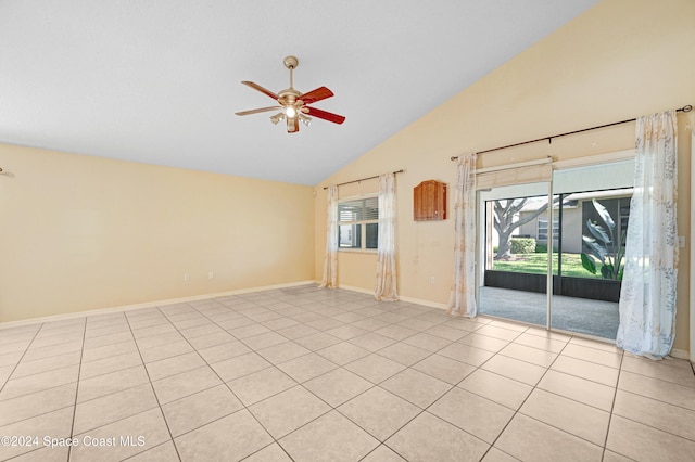 tiled empty room with ceiling fan and high vaulted ceiling