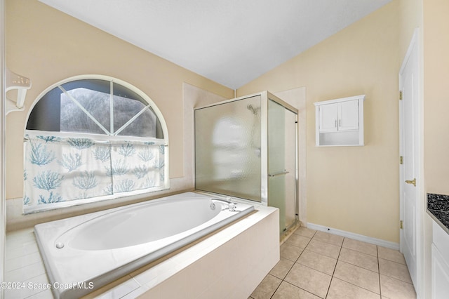 bathroom featuring tile patterned flooring, vanity, separate shower and tub, and vaulted ceiling