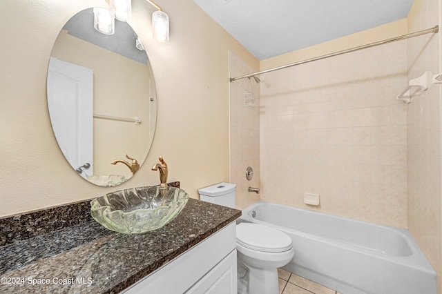 full bathroom with tile patterned floors, toilet, vanity, and tiled shower / bath