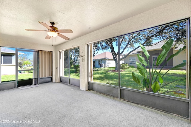 unfurnished sunroom featuring a wealth of natural light and ceiling fan