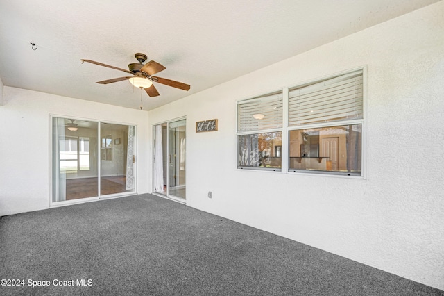 interior space with carpet and ceiling fan