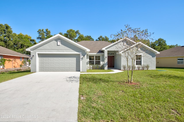 view of front of property with a garage and a front yard