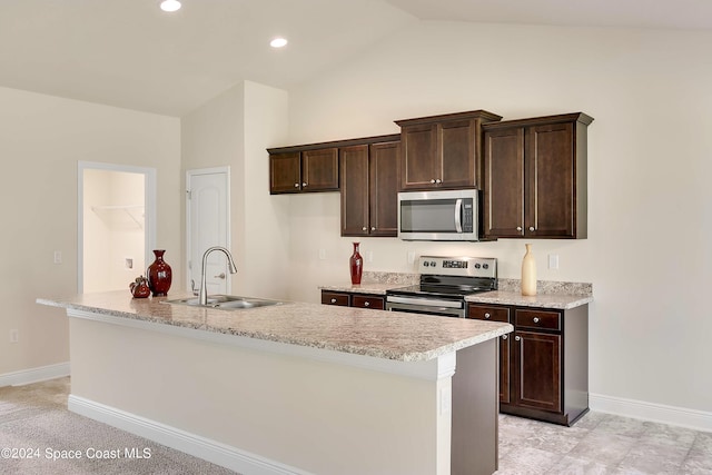 kitchen featuring a kitchen island with sink, appliances with stainless steel finishes, sink, and lofted ceiling