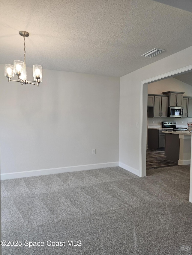 713 Degroodt Rd SW, Palm Bay, FL 32908 - unfurnished dining area featuring a chandelier, dark colored carpet, baseboards, and a textured ceiling