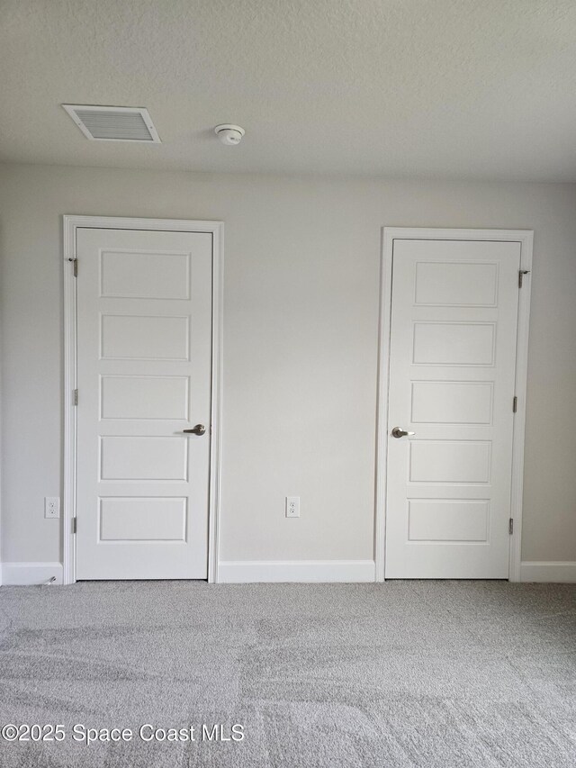 713 Degroodt Rd SW, Palm Bay, FL 32908 - carpeted spare room with baseboards, a smoke detector, and a textured ceiling