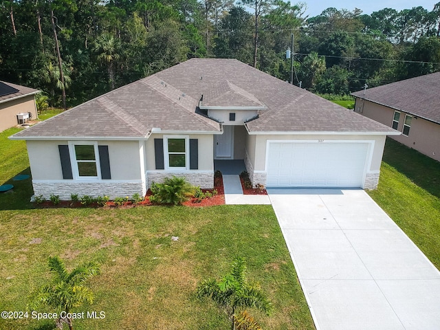 view of front of property with a front lawn and a garage