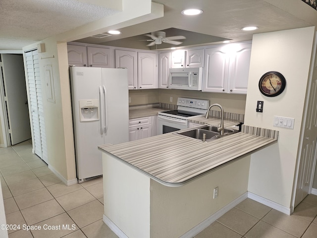 kitchen with ceiling fan, sink, kitchen peninsula, white appliances, and white cabinets