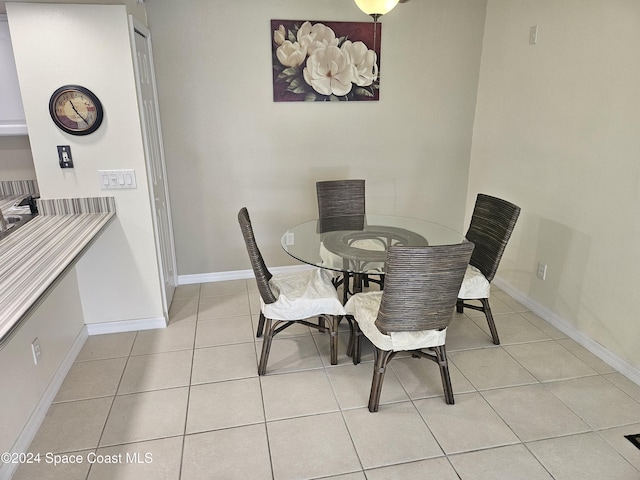 dining space featuring light tile patterned floors