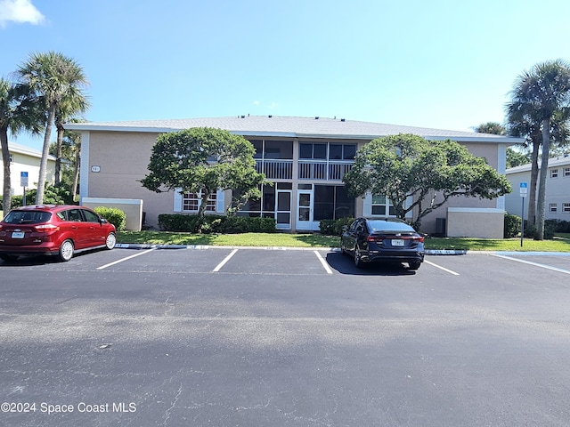 981 Sonesta Ave NE Unit 203, Palm Bay, FL 32905 - view of property featuring uncovered parking