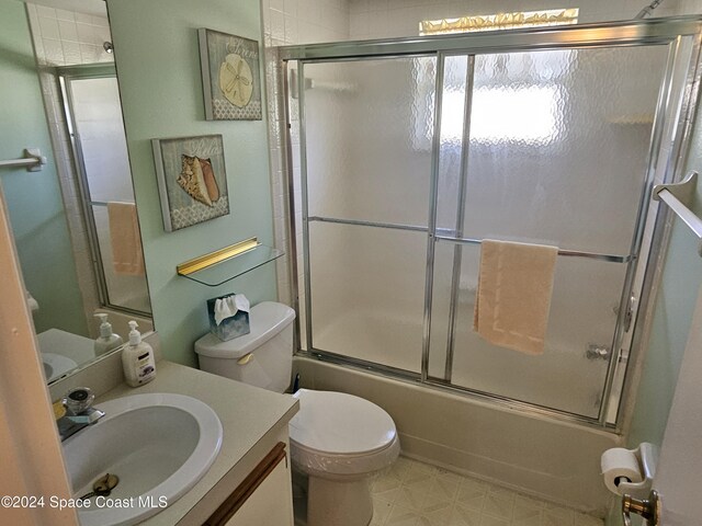 981 Sonesta Ave NE Unit 203, Palm Bay, FL 32905 - full bathroom with vanity, enclosed tub / shower combo, and toilet