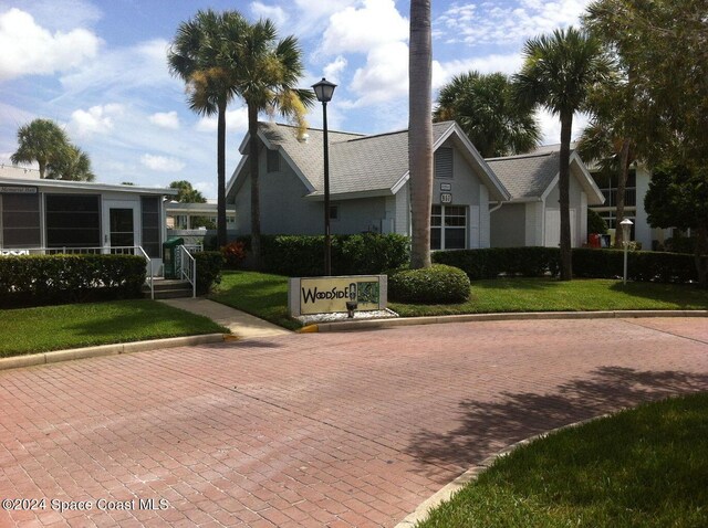 981 Sonesta Ave NE Unit 203, Palm Bay, FL 32905 - view of front of property featuring a front yard and stucco siding