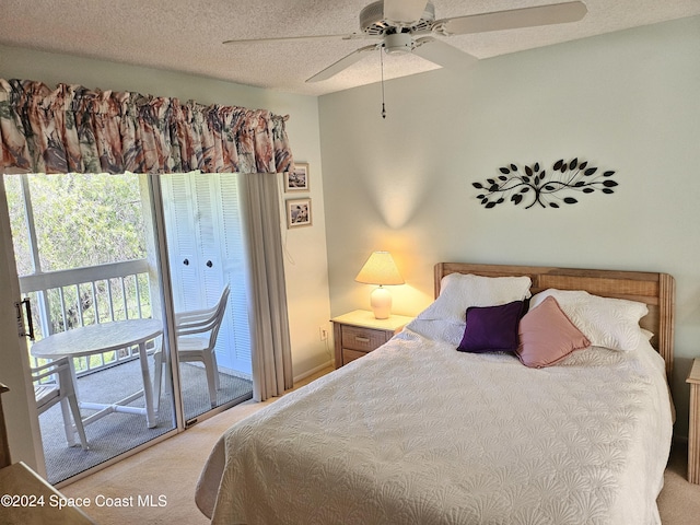 981 Sonesta Ave NE Unit 203, Palm Bay, FL 32905 - bedroom featuring a ceiling fan, a textured ceiling, light carpet, and access to exterior