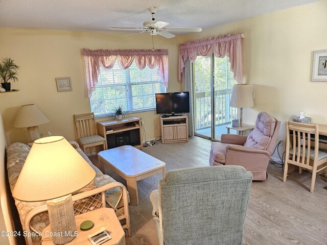 981 Sonesta Ave NE Unit 203, Palm Bay, FL 32905 - living room featuring a textured ceiling, ceiling fan, and light wood-style flooring