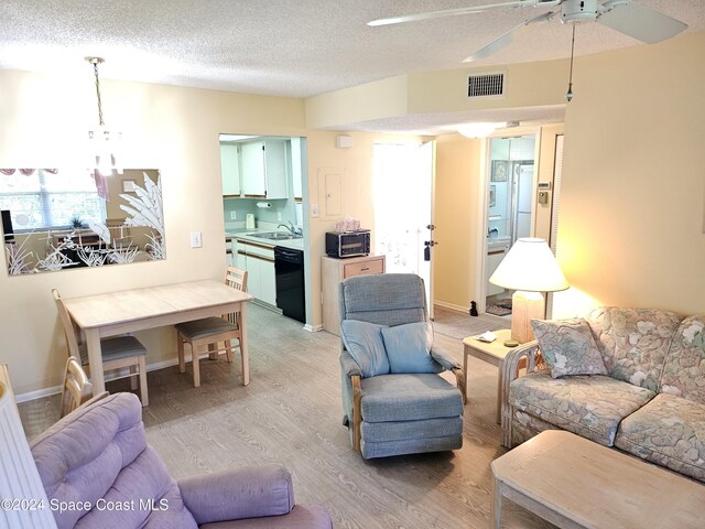 981 Sonesta Ave NE Unit 203, Palm Bay, FL 32905 - living room with a ceiling fan, a textured ceiling, visible vents, a toaster, and light wood finished floors