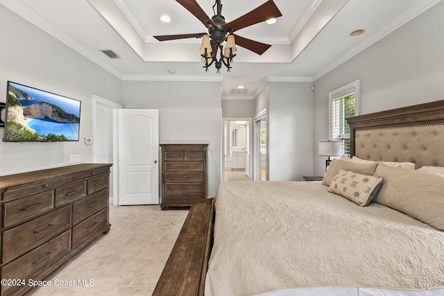 tiled bedroom featuring connected bathroom, crown molding, a tray ceiling, and ceiling fan