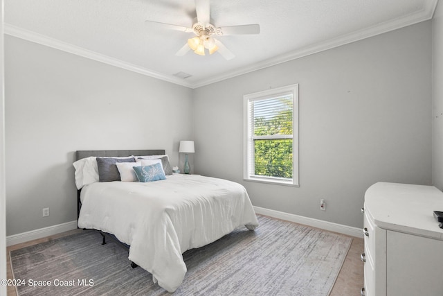 bedroom with crown molding and ceiling fan