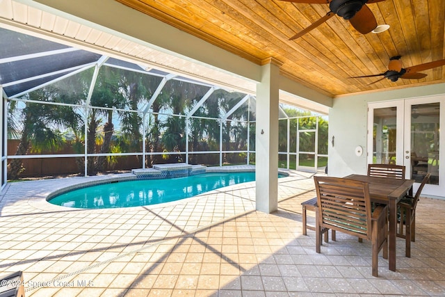 view of pool featuring a lanai, a patio, and ceiling fan