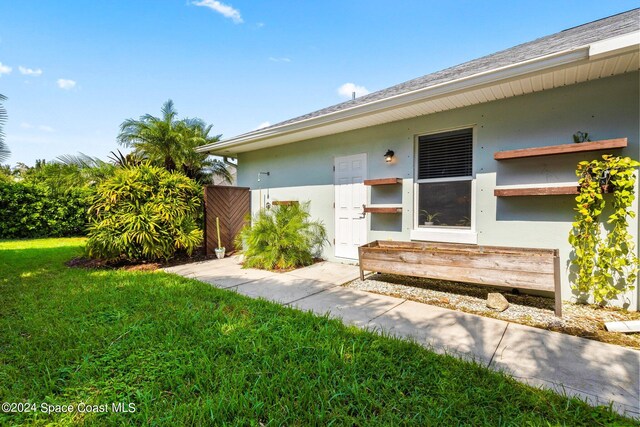 property entrance with a yard