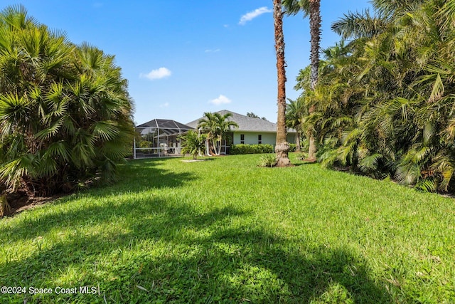 view of yard featuring a lanai